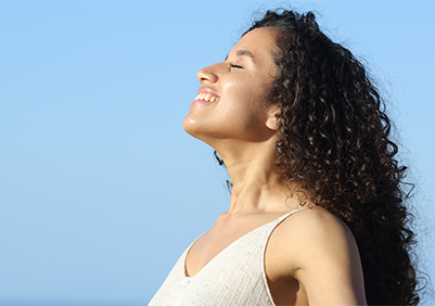 A woman taking a deep breath in the fresh air